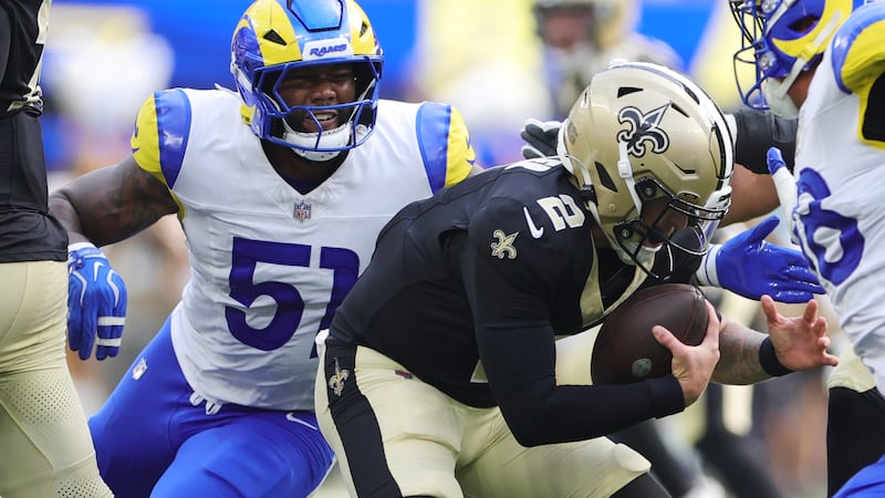 Saints quarterback Spencer Rattler (2) is tackled by Los Angeles Rams linebacker Tomon Fox...