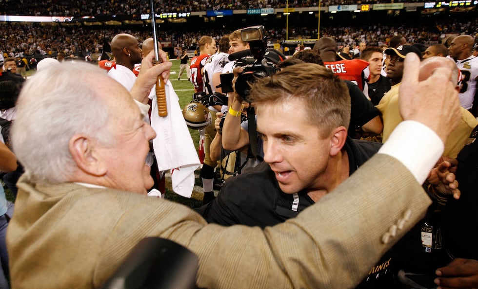 File-This Sept. 25, 2006, file photo shows New Orleans Saints owner Tom Benson, left, hugging...