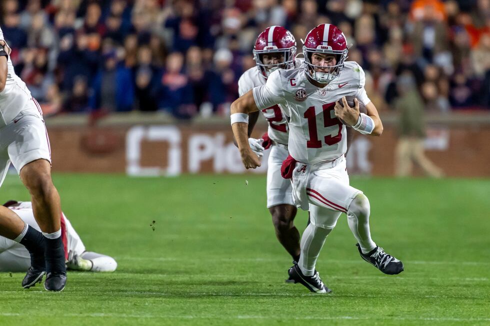 Alabama quarterback Ty Simpson (15) runs the ball against Auburn during the first half of an...