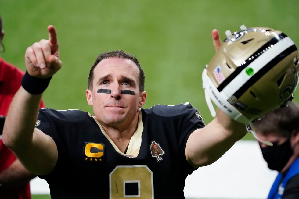 New Orleans Saints quarterback Drew Brees gestures to his family and fans after an NFL...