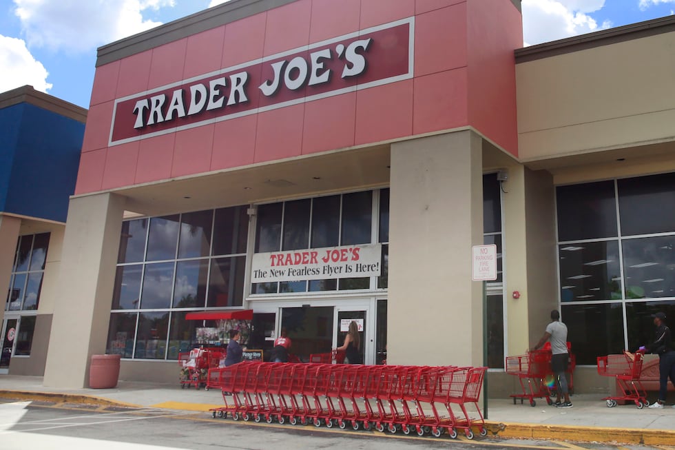 FILE - People stand in line waiting to enter Trader Joe's to buy groceries in Pembroke Pines,...