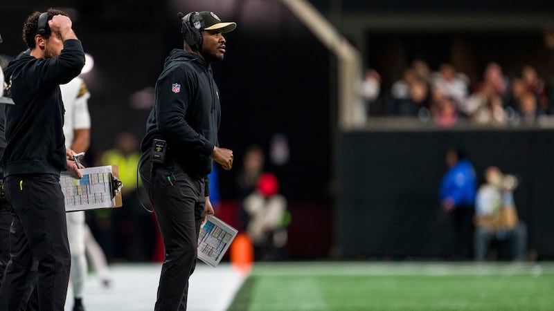 New Orleans Saints wide receivers coach Kodi Burns works during the first half of an NFL...