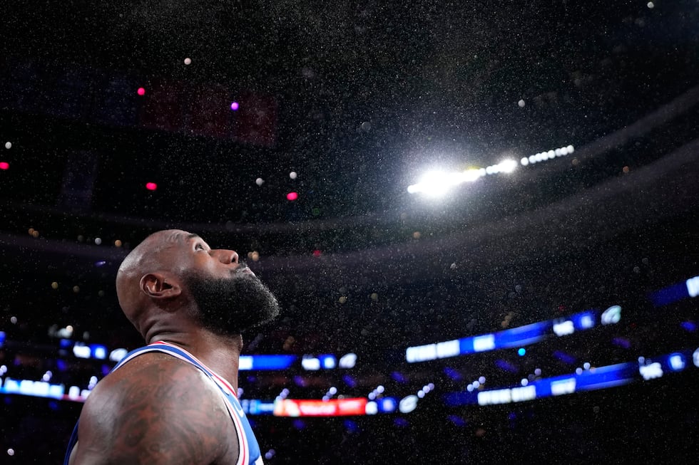 Philadelphia 76ers' LeBron James tosses chalk into the air before an NBA basketball game...