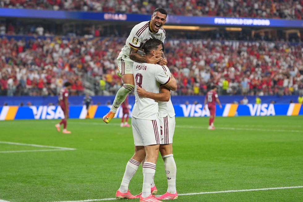Spain's Pedro Porro, top, congrats Spain's Mikel Merino, right, after scored during the World...